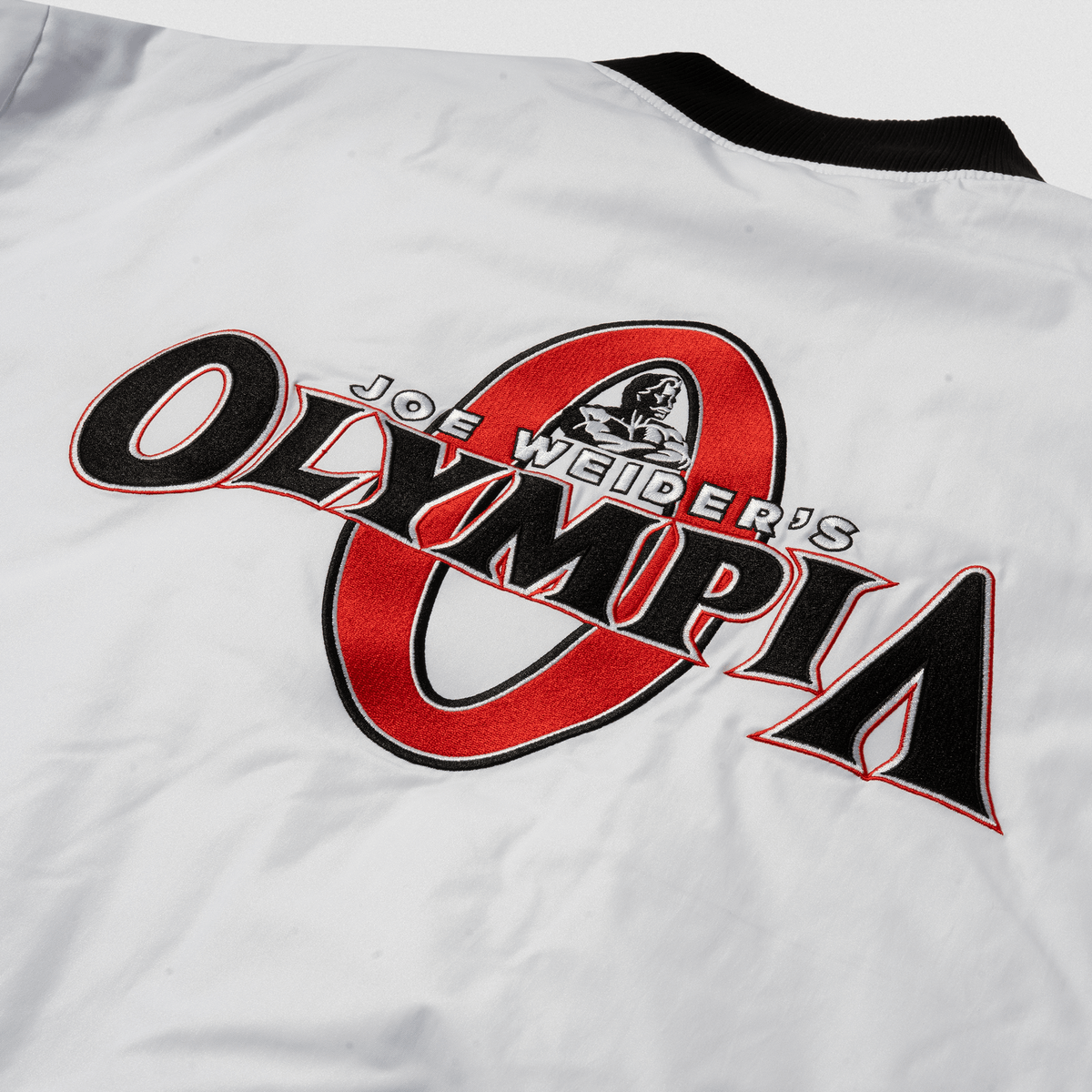 7. Olympia Signature Bomber Jacket in White – Back Logo Close-Up
