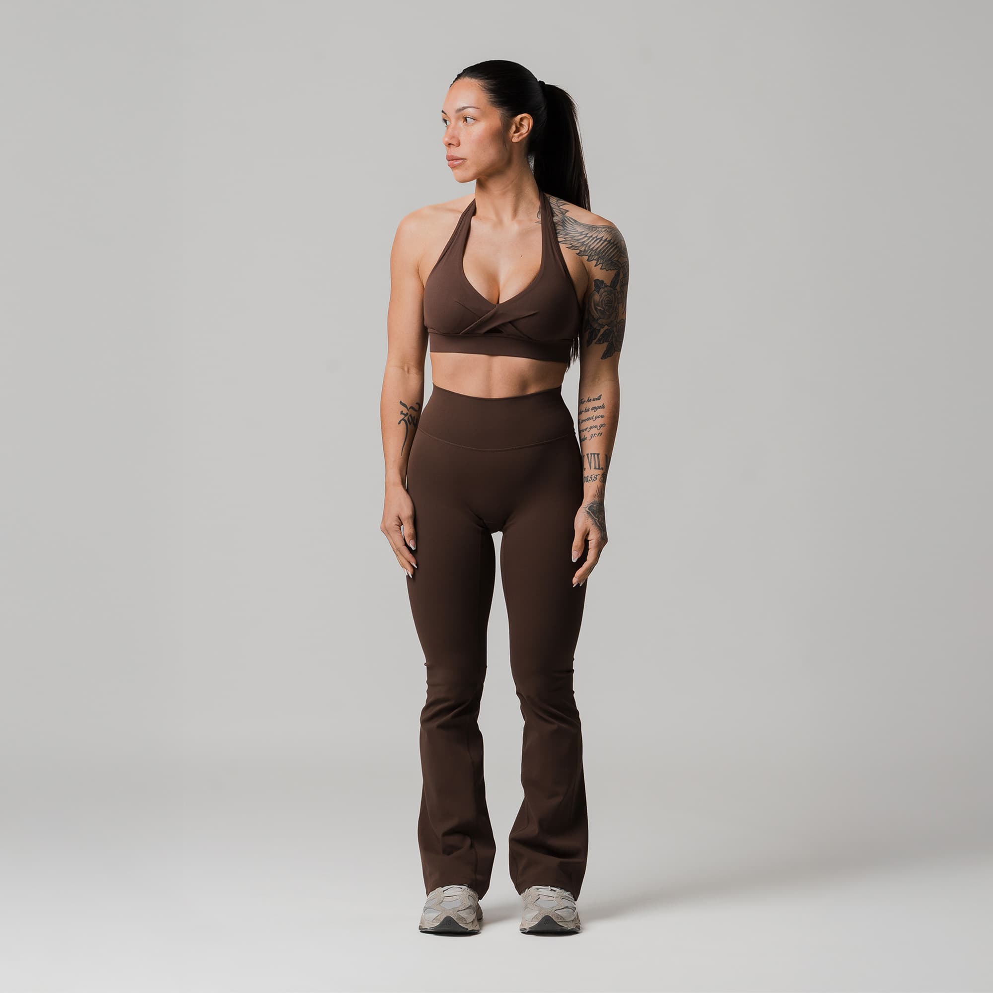 athlete wearing brown axis flare leggings full body shot front view