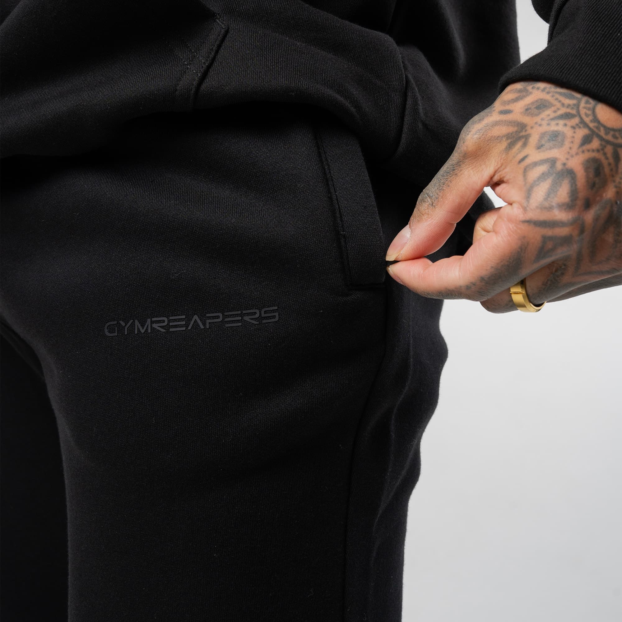 athlete wearing axis joggers close up detail shot of pocket and logo details