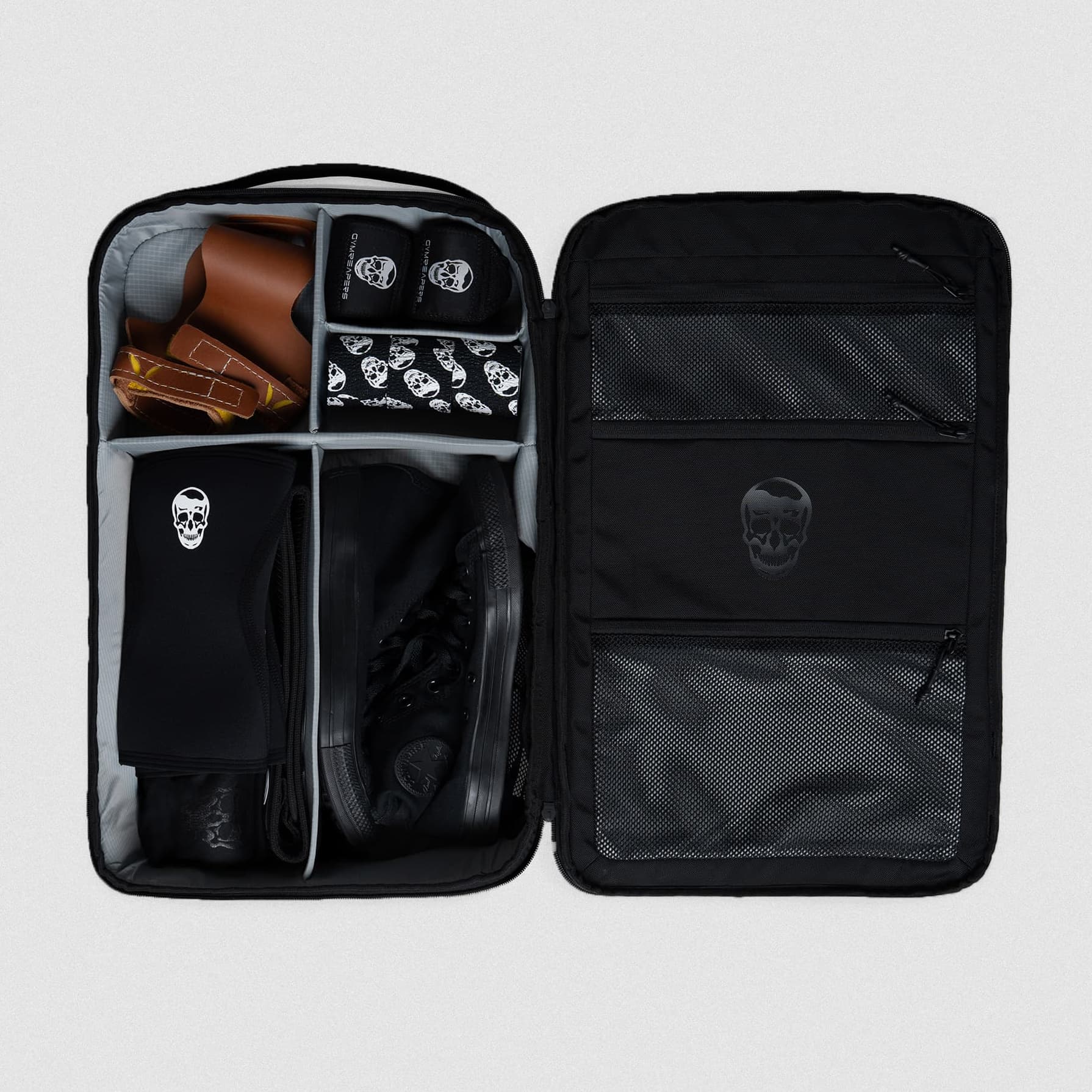 Shot of Vanguard™ Backpack laying down open showcasing the dividers with items in them