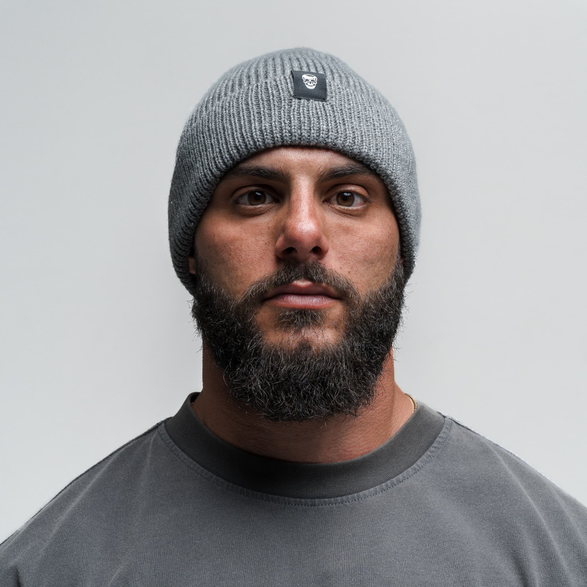 Athlete wearing Ribbed Knit Skull Beanie - Dark Gray front view