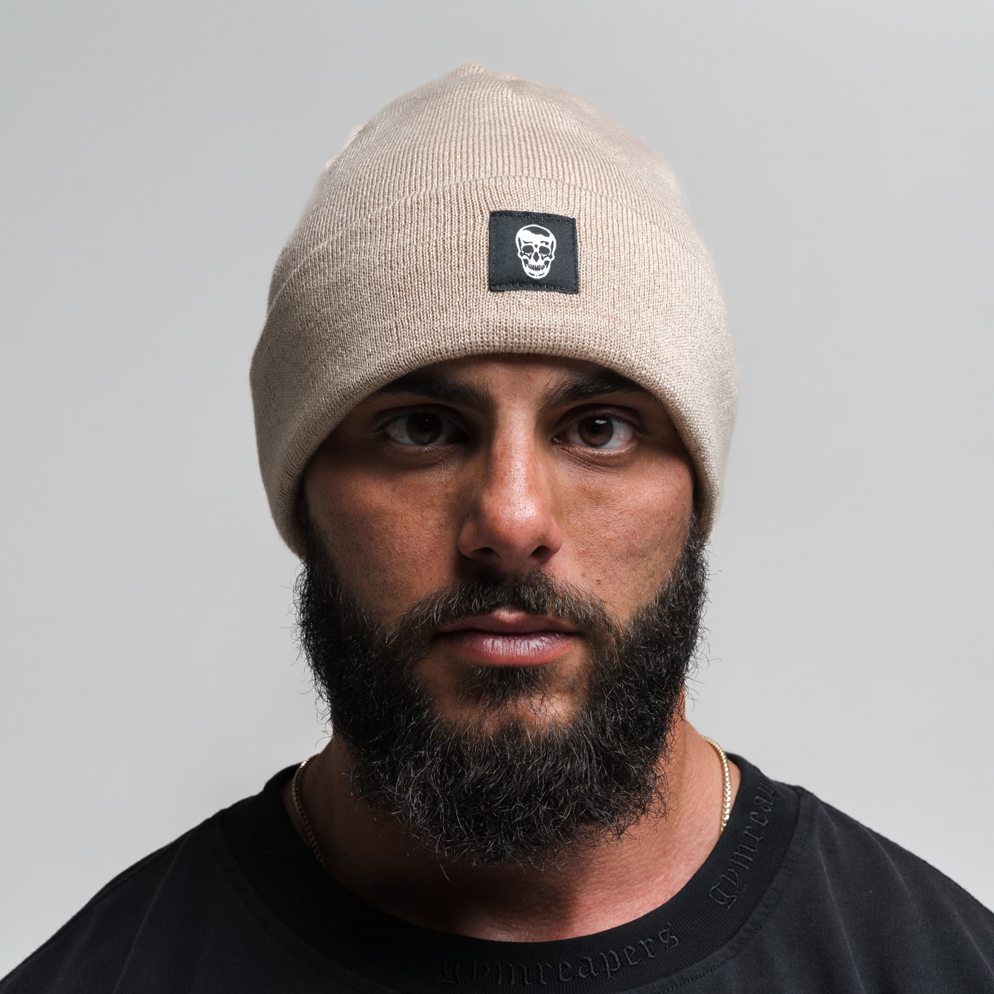 Athlete wearing Skull Knit Cuff Beanie - Tan front view