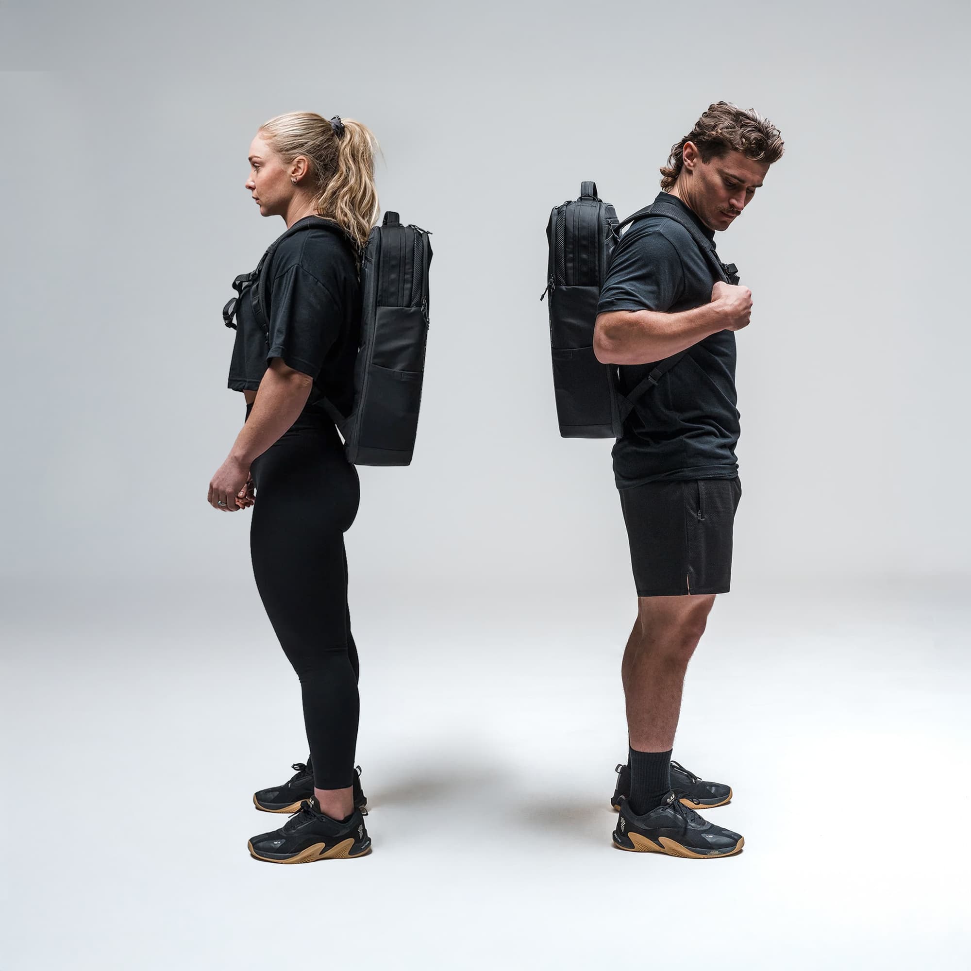 Athletes wearing the Vanguard™ Backpack standing back to back