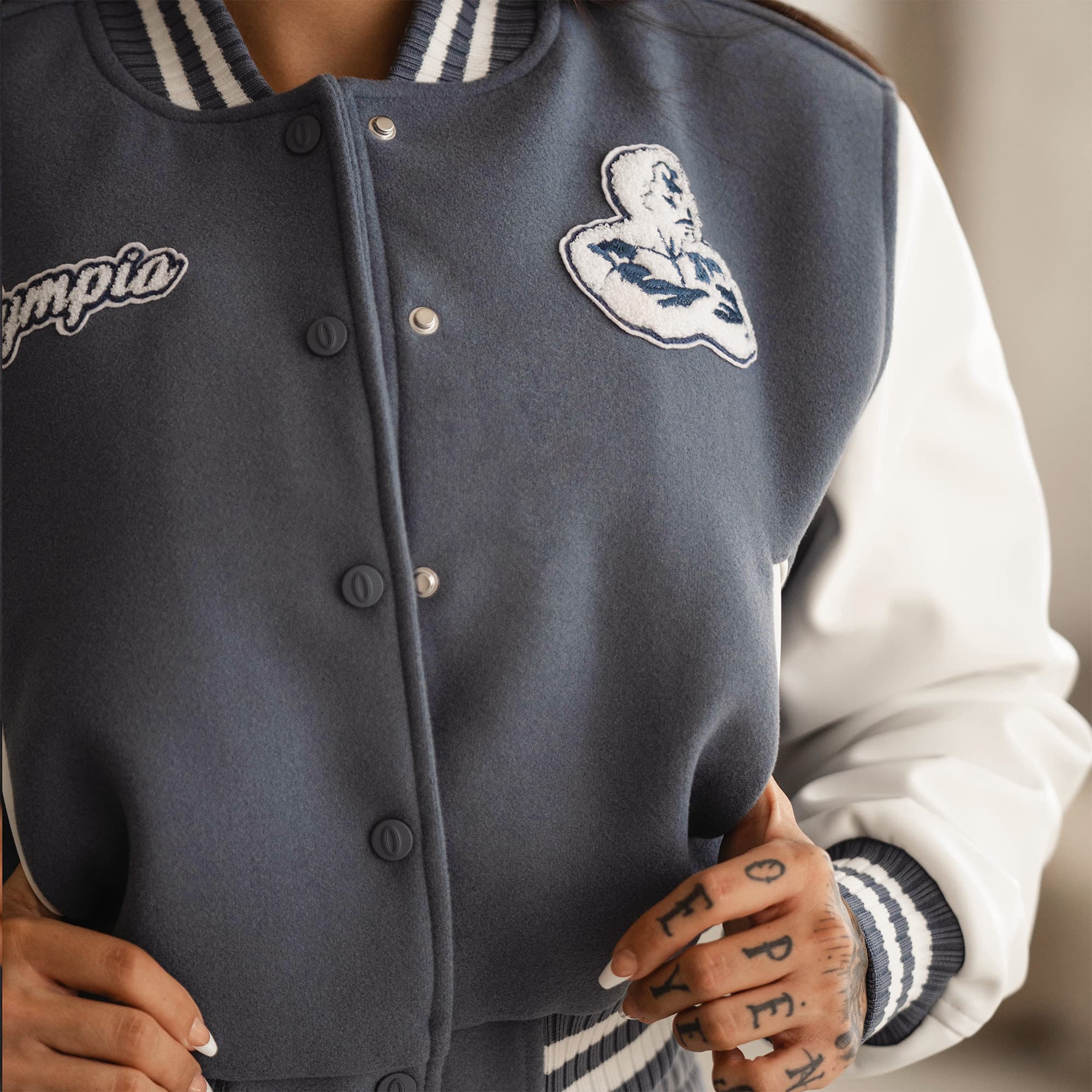 cropped varsity jacket on athlete close up of button details