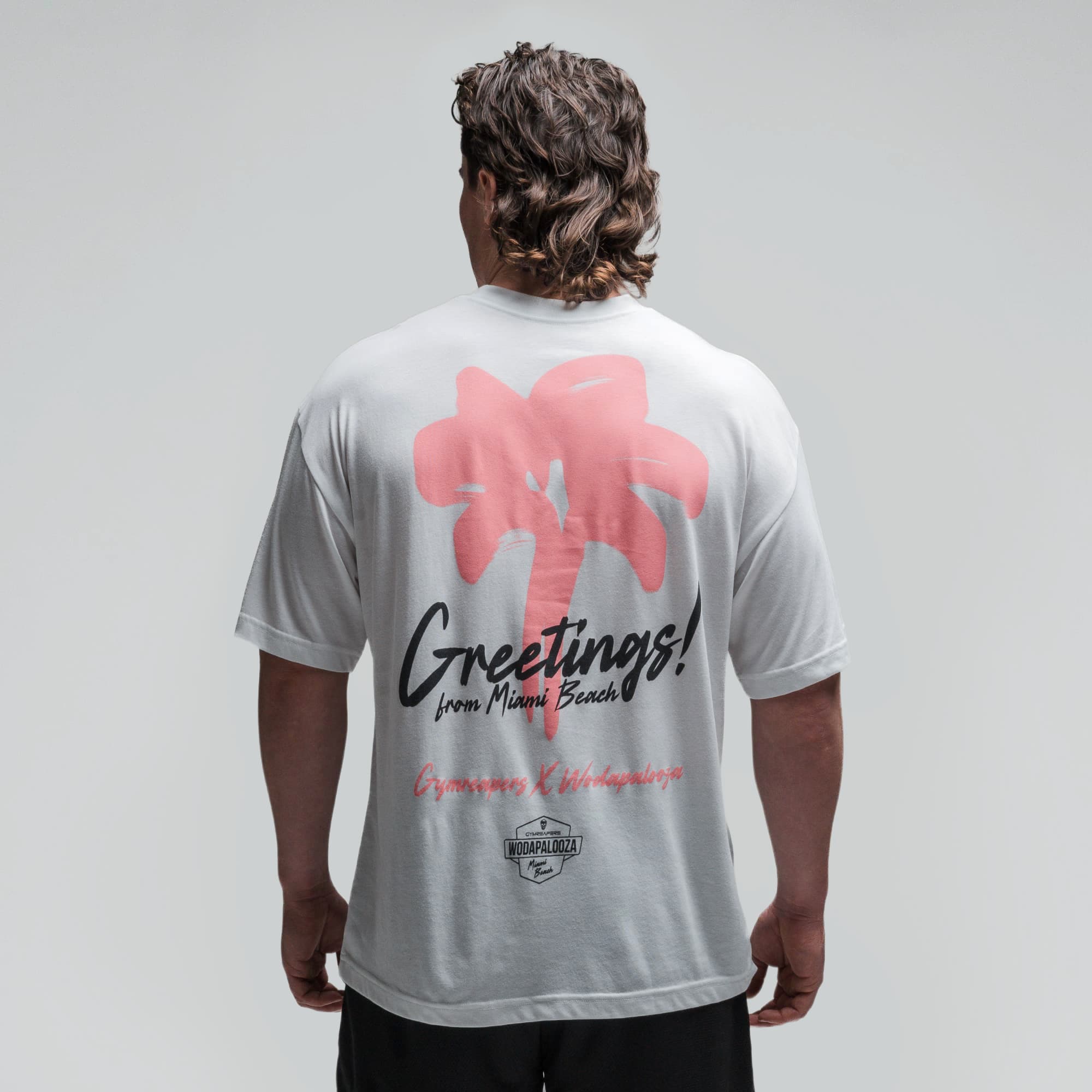 Athlete wearing the Greetings Tee half body shot back side