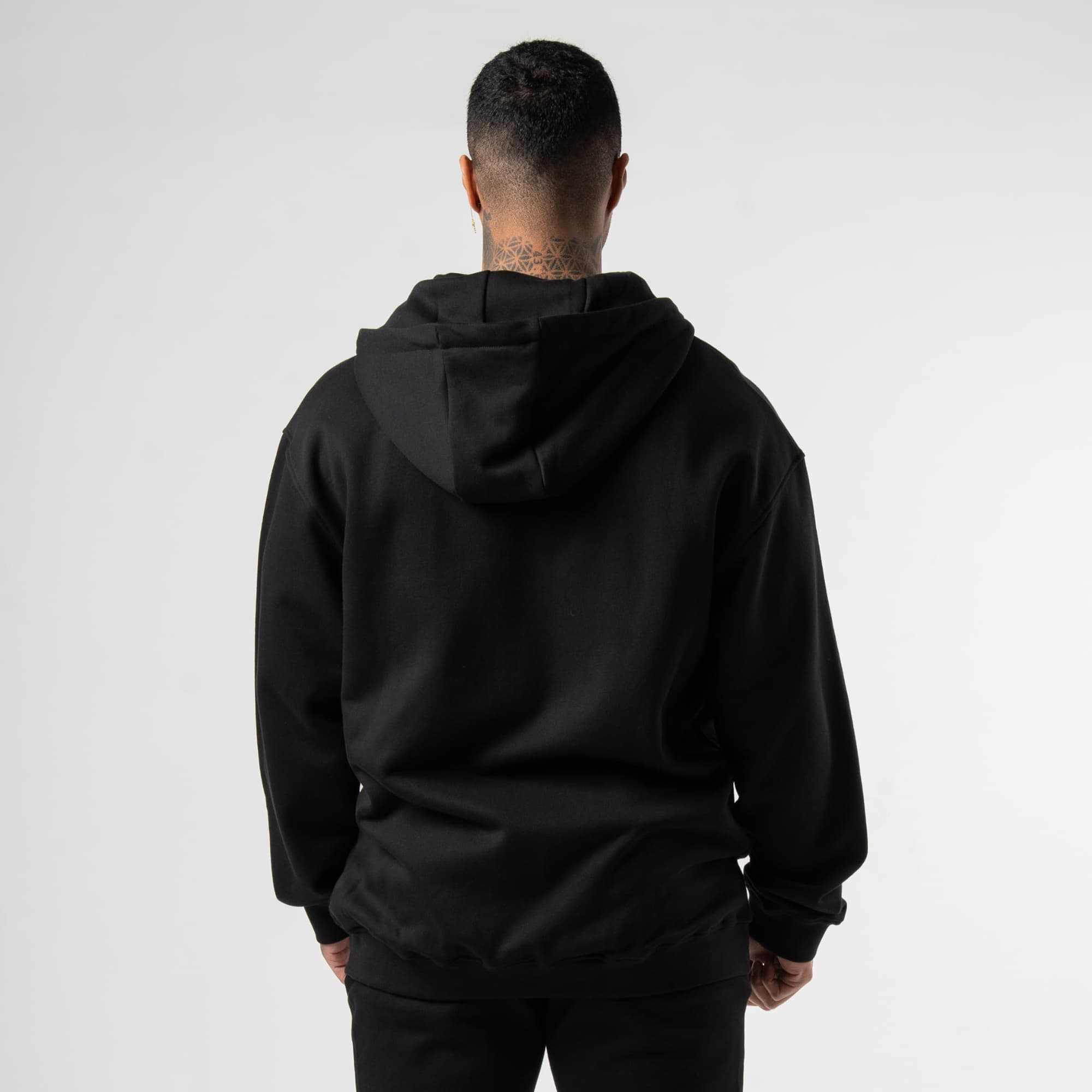 athlete wearing the black/black zip hoodie back view