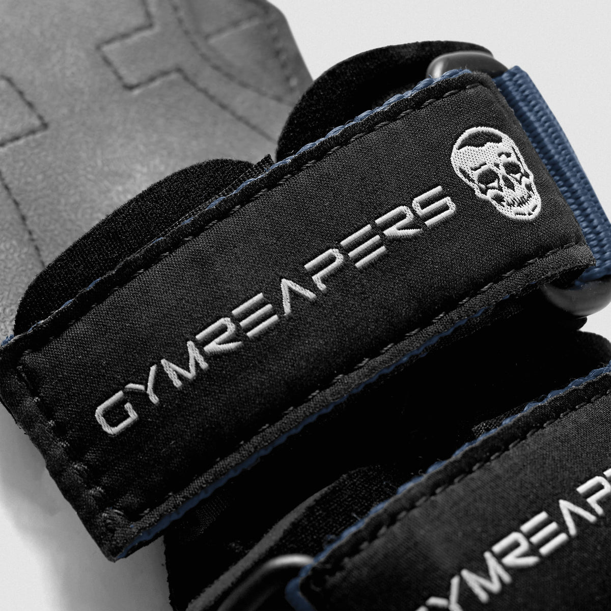 macro zoom of the Gymreapers logo on navy weightlifting grips
