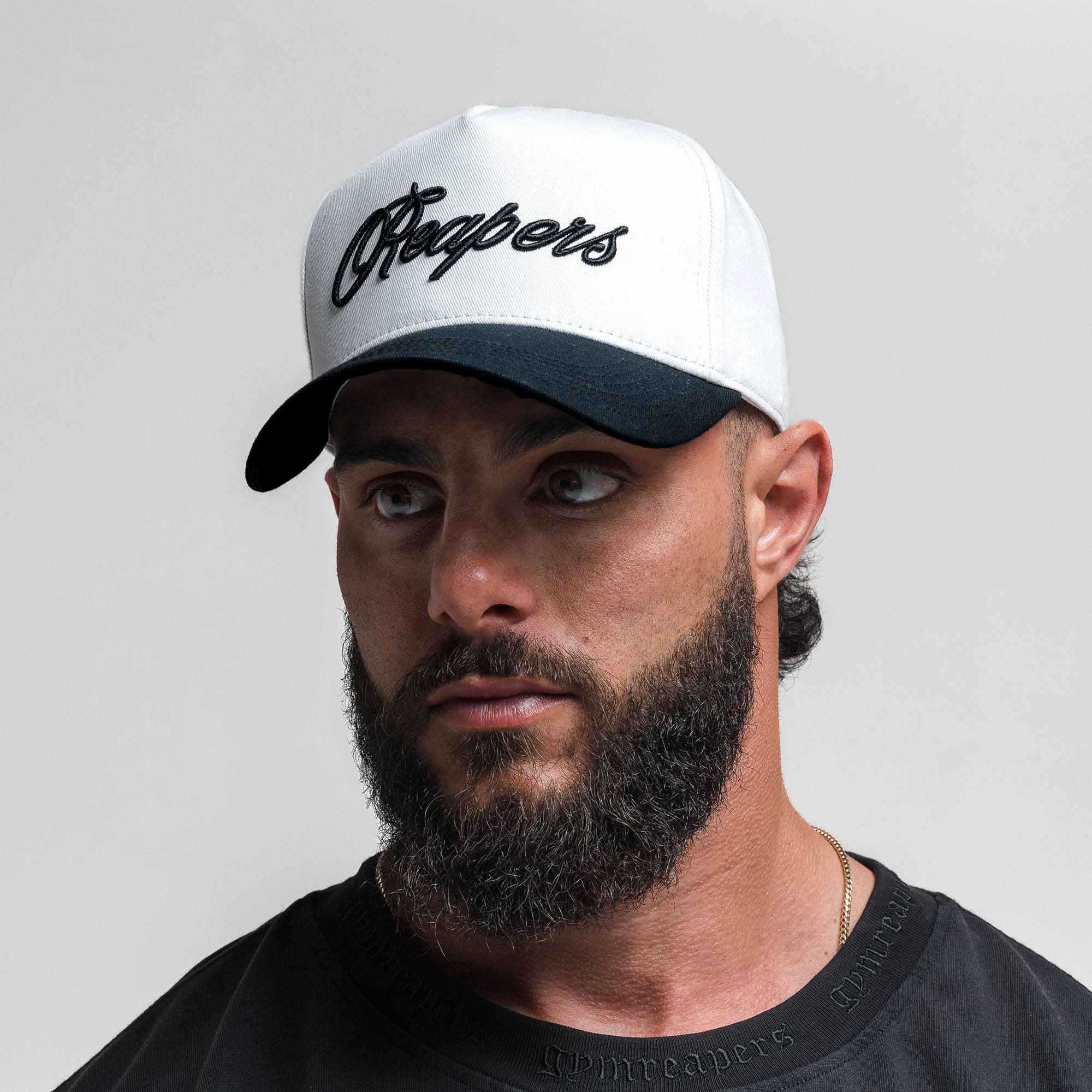 Athlete wearing Reapers 5-Panel Cotton Hat - White/Black front view