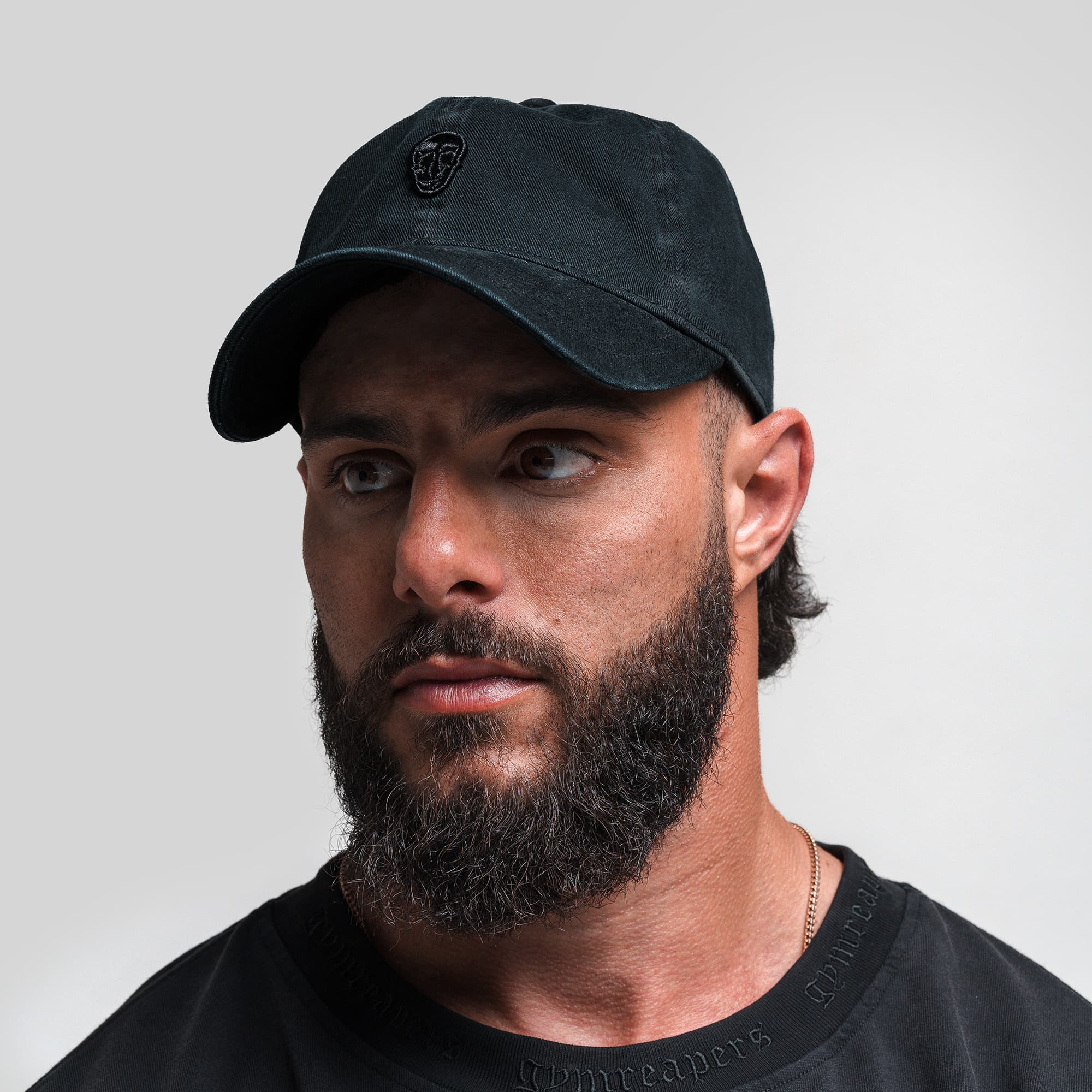 Athlete wearing Washed 6-Panel Dad Hat - Black/Black front view