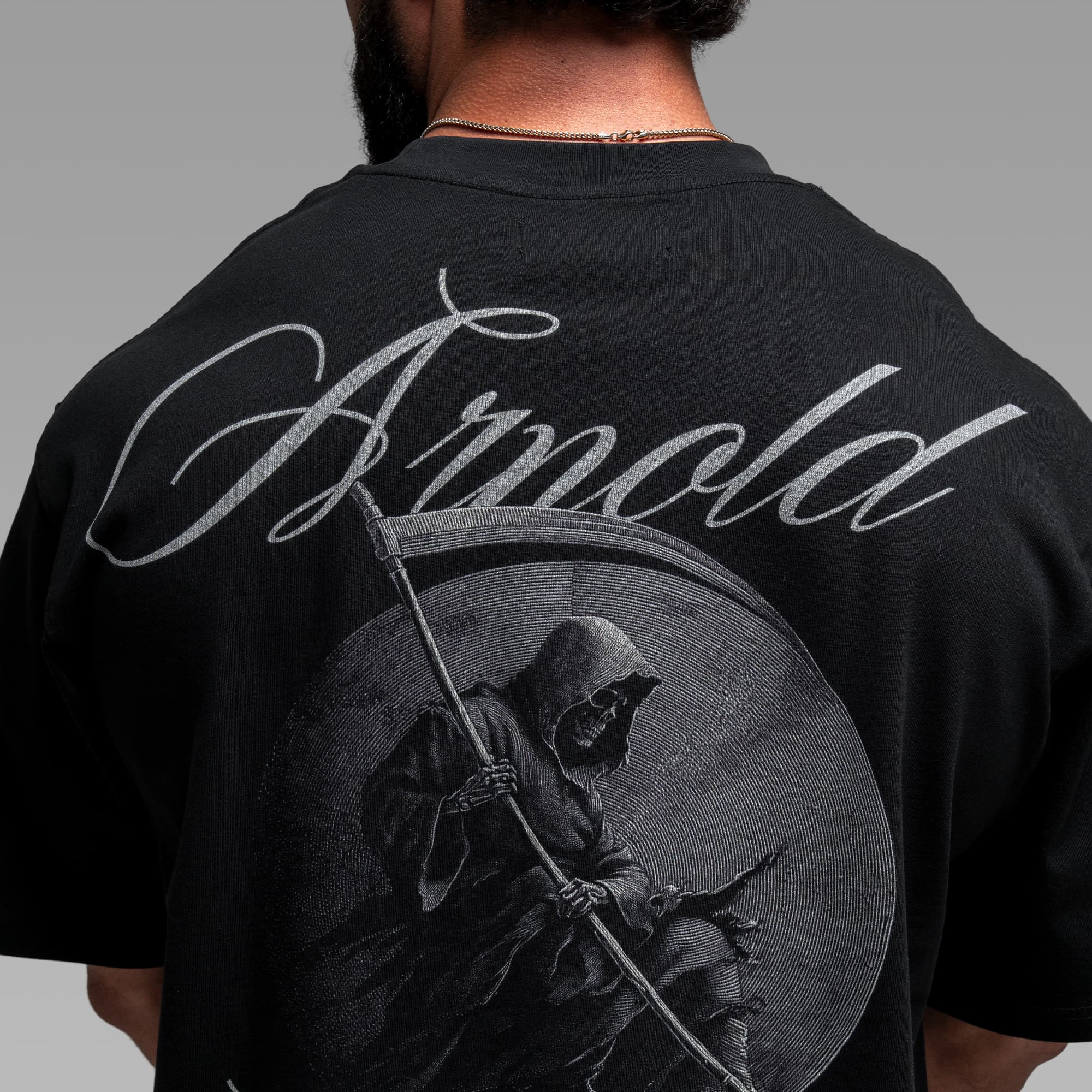 Athlete wearing the Midnight Reaper Tee close up shot of back graphic