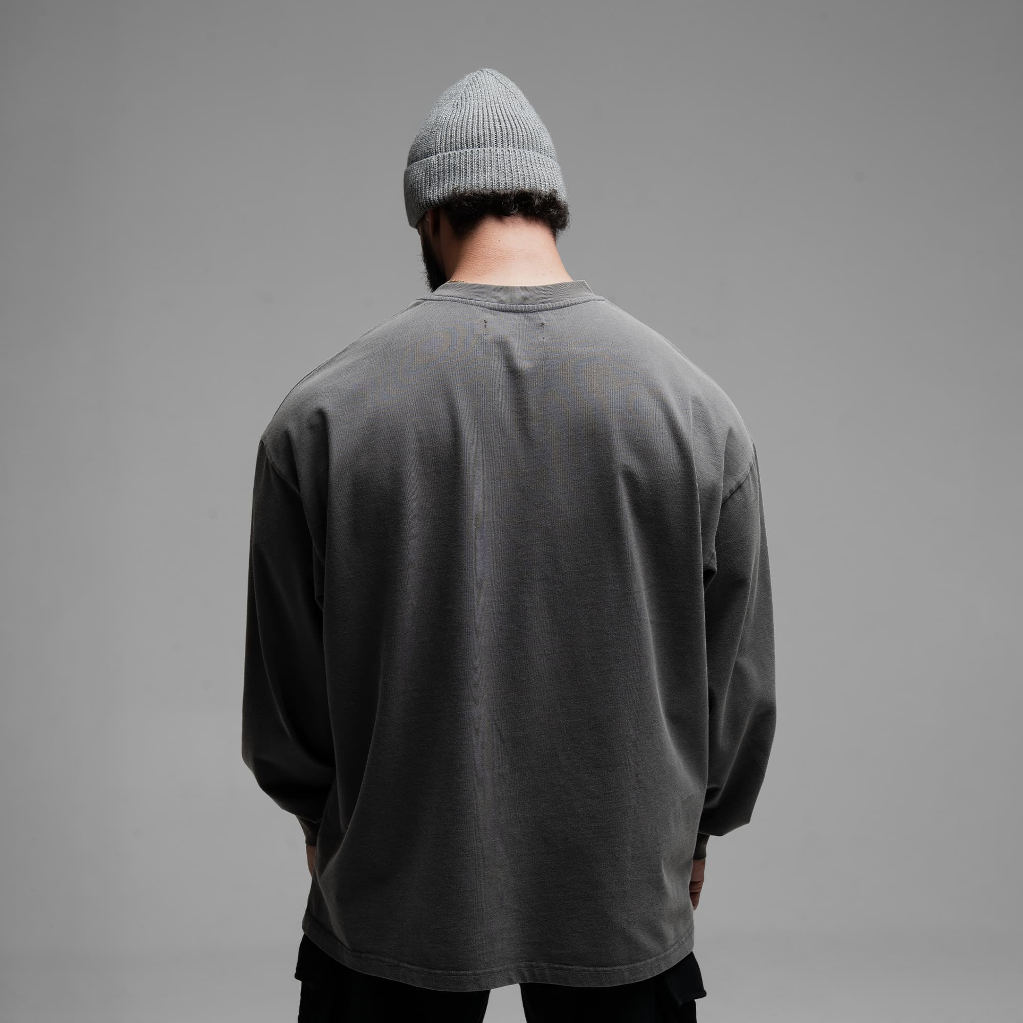 Athlete wearing Reaper Chainscript Long Sleeve Shirt half body shot back side