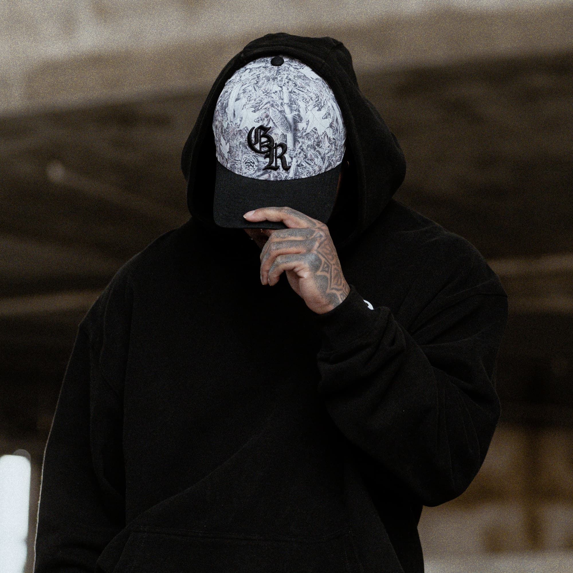 lifestyle shot of athlete wearing the Camo Initial Trucker Hat