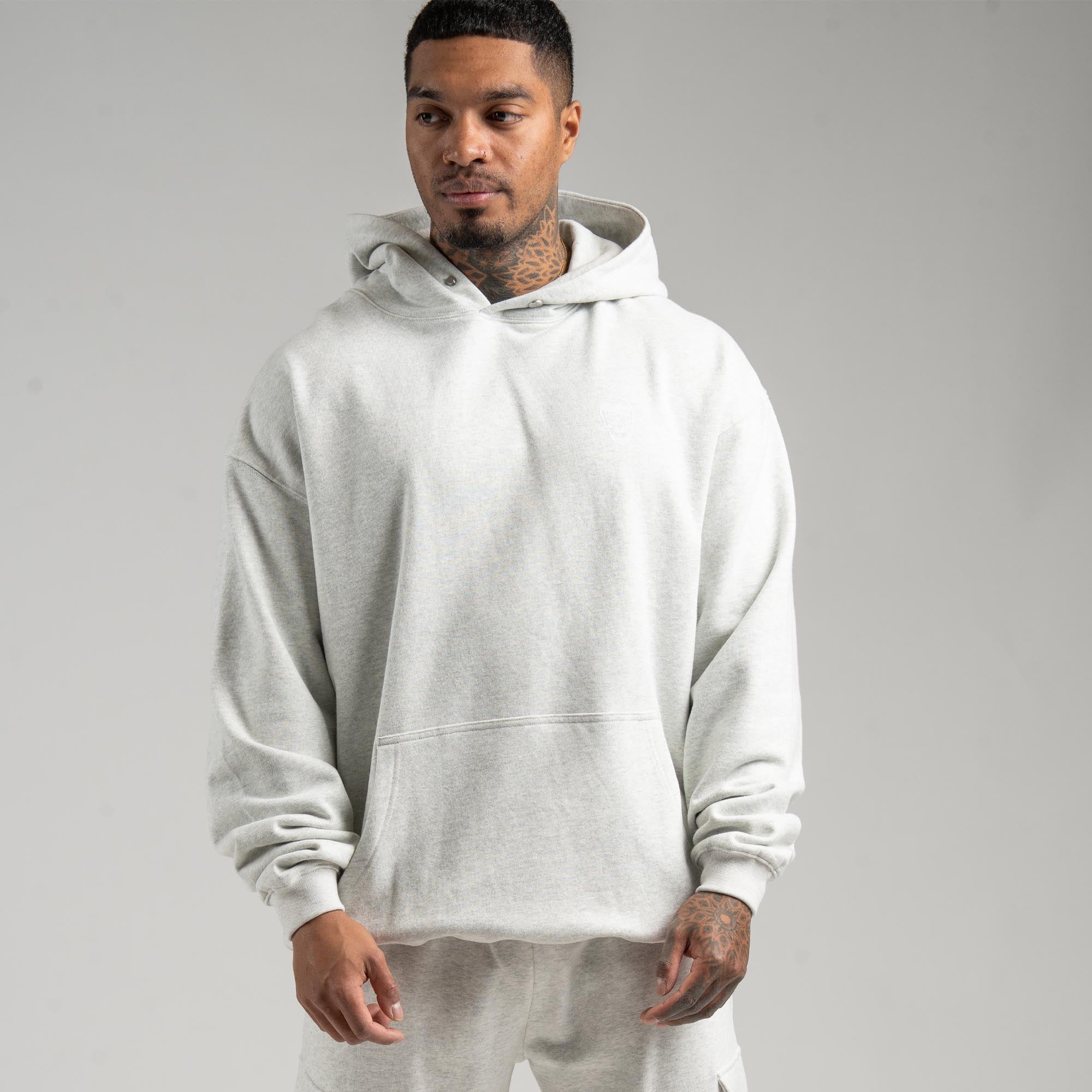 athlete wearing the light heather gray heavyweight hoodie