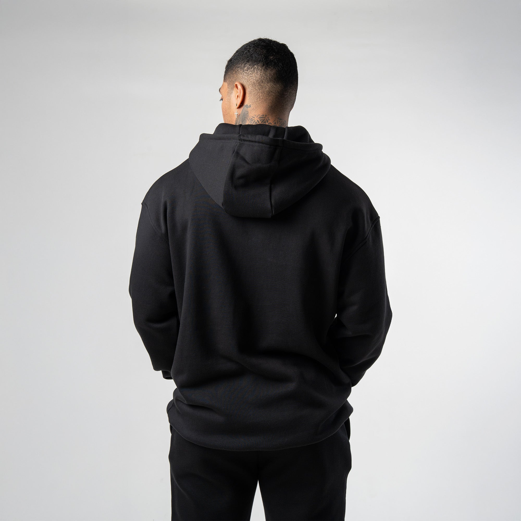 athlete wearing black/white axis mockneck hoodie back view