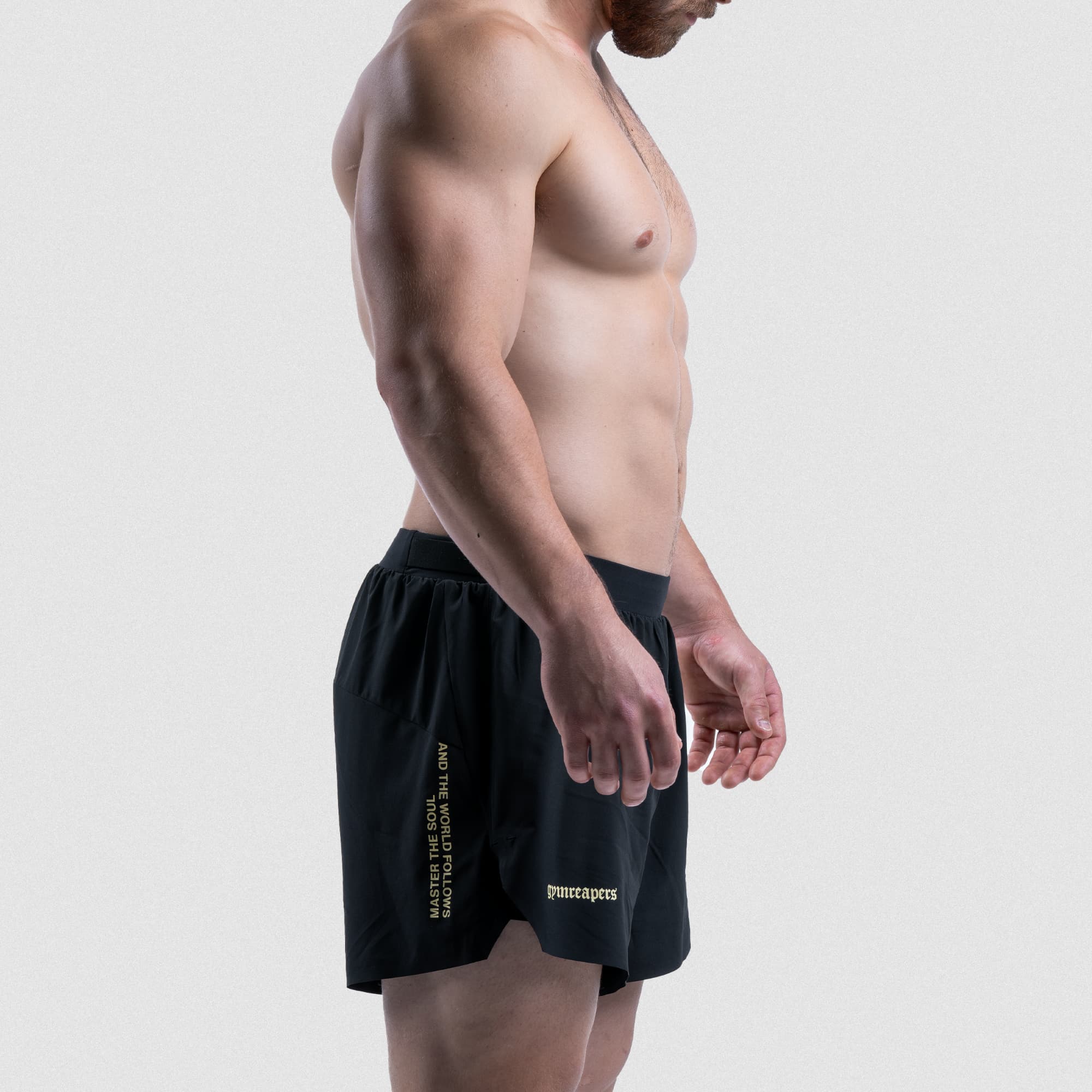 Side view of athlete wearing Master the Soul running shorts with Gymreapers logo and quote graphic