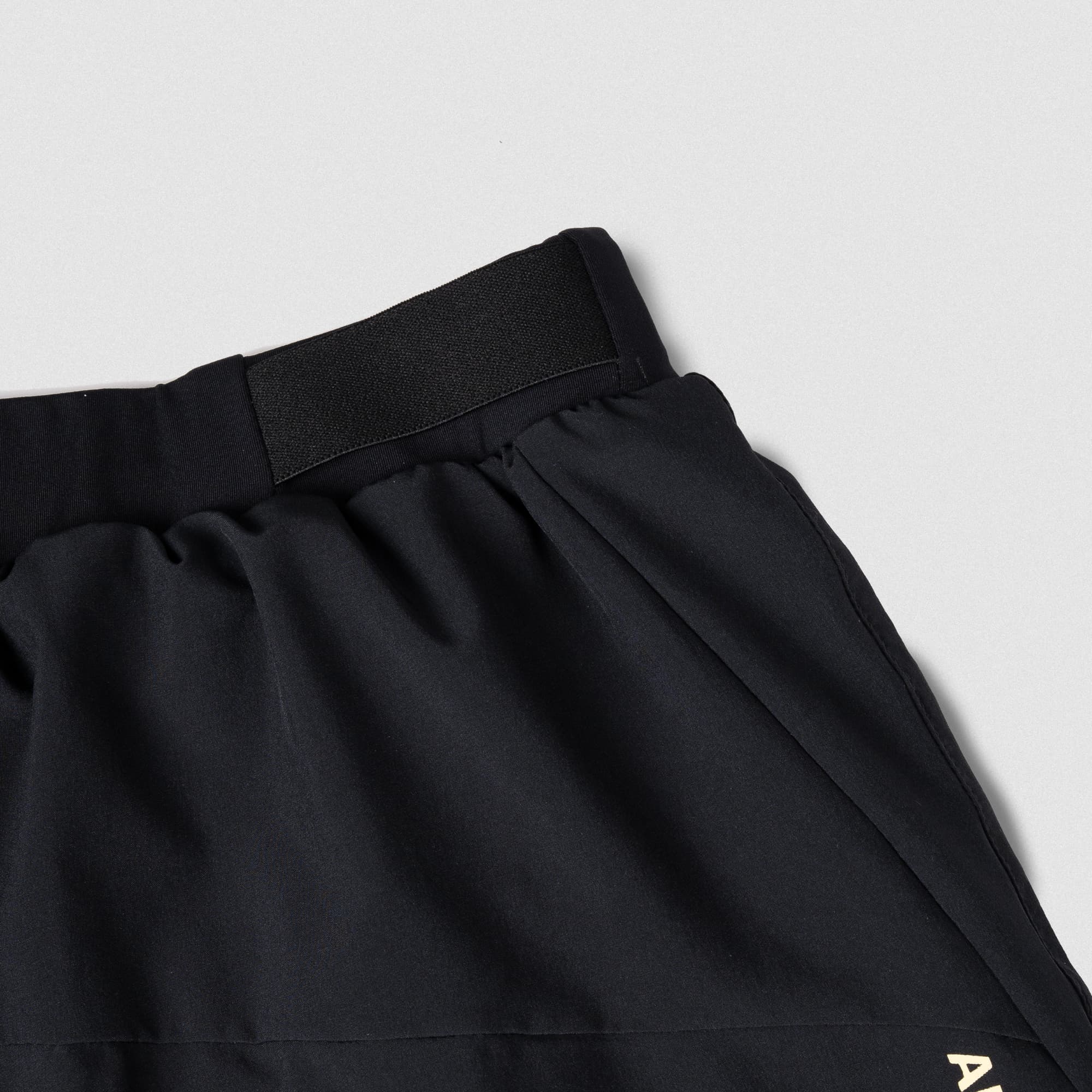 Close-up of elastic waistband and side panel construction on Gymreapers running shorts, highlighting detail and stretch material