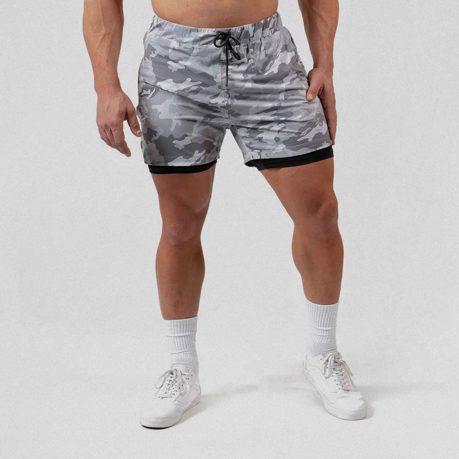 React training shorts white camo color way on athlete holding the side