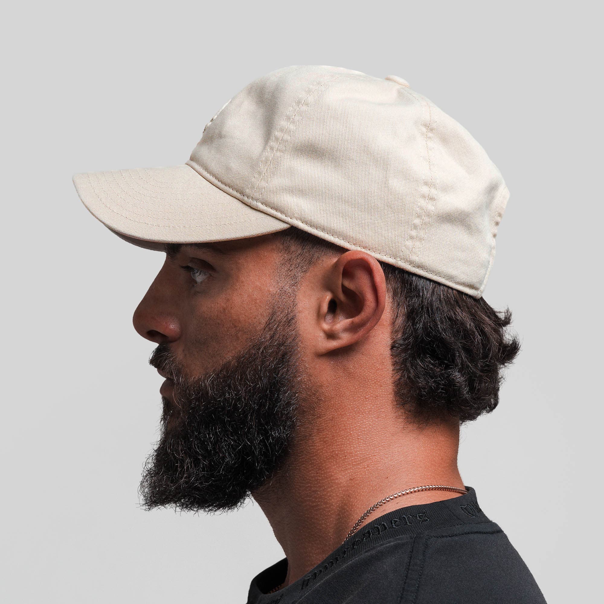 Athlete wearing Washed 6-Panel Dad Hat - Tan side view