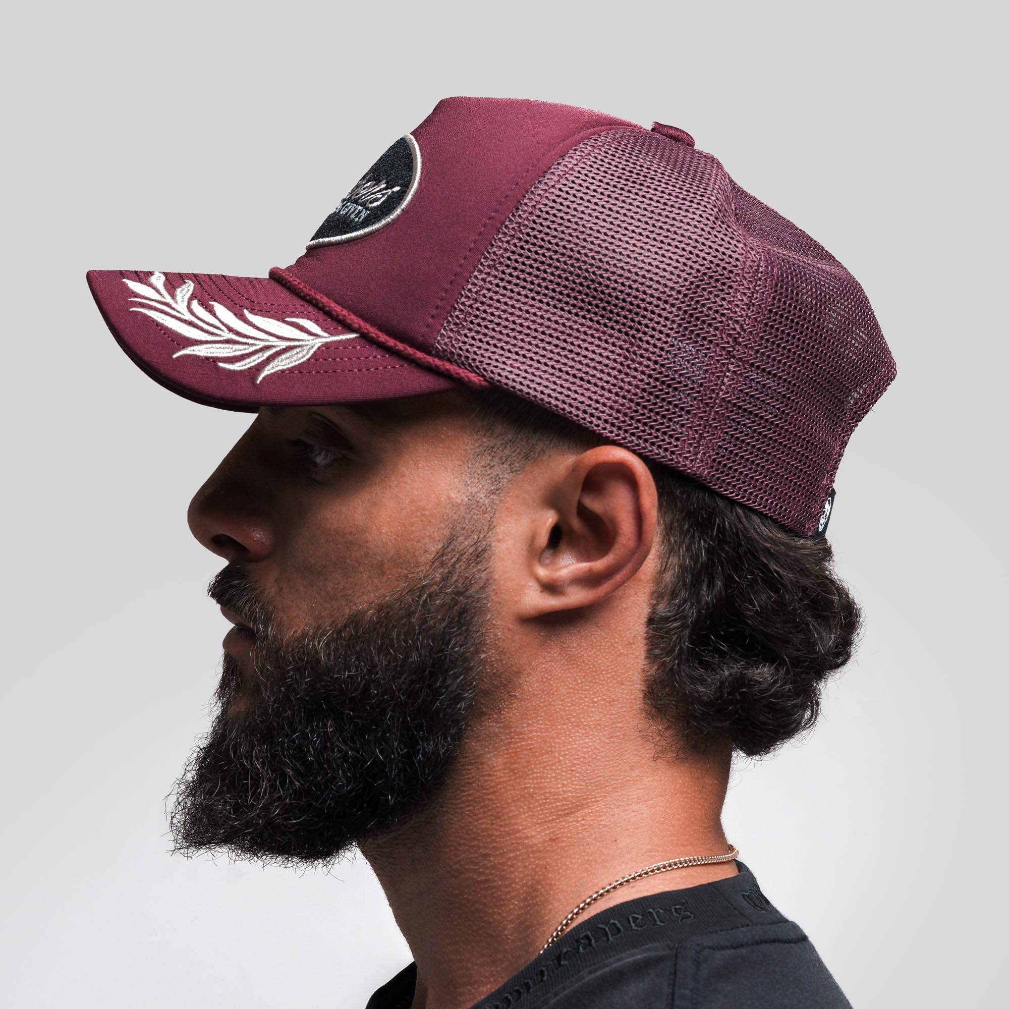 Athlete wearing Laurel Foam Trucker Hat - Maroon side view