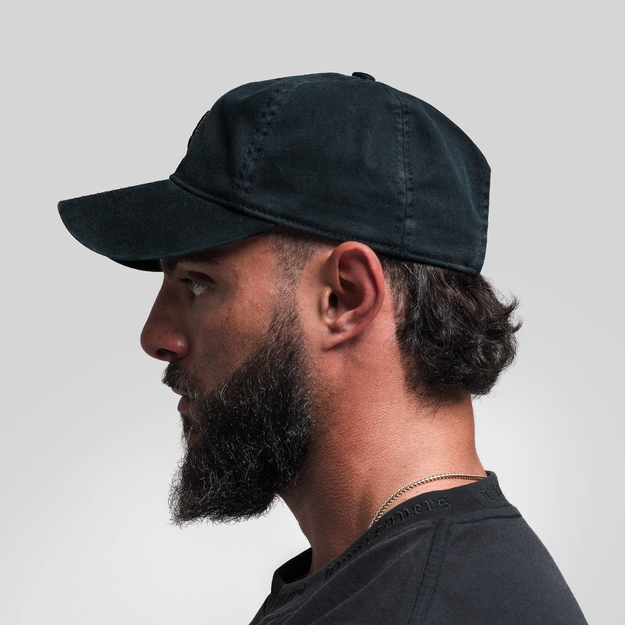 Athlete wearing Washed 6-Panel Dad Hat - Black/Black side view