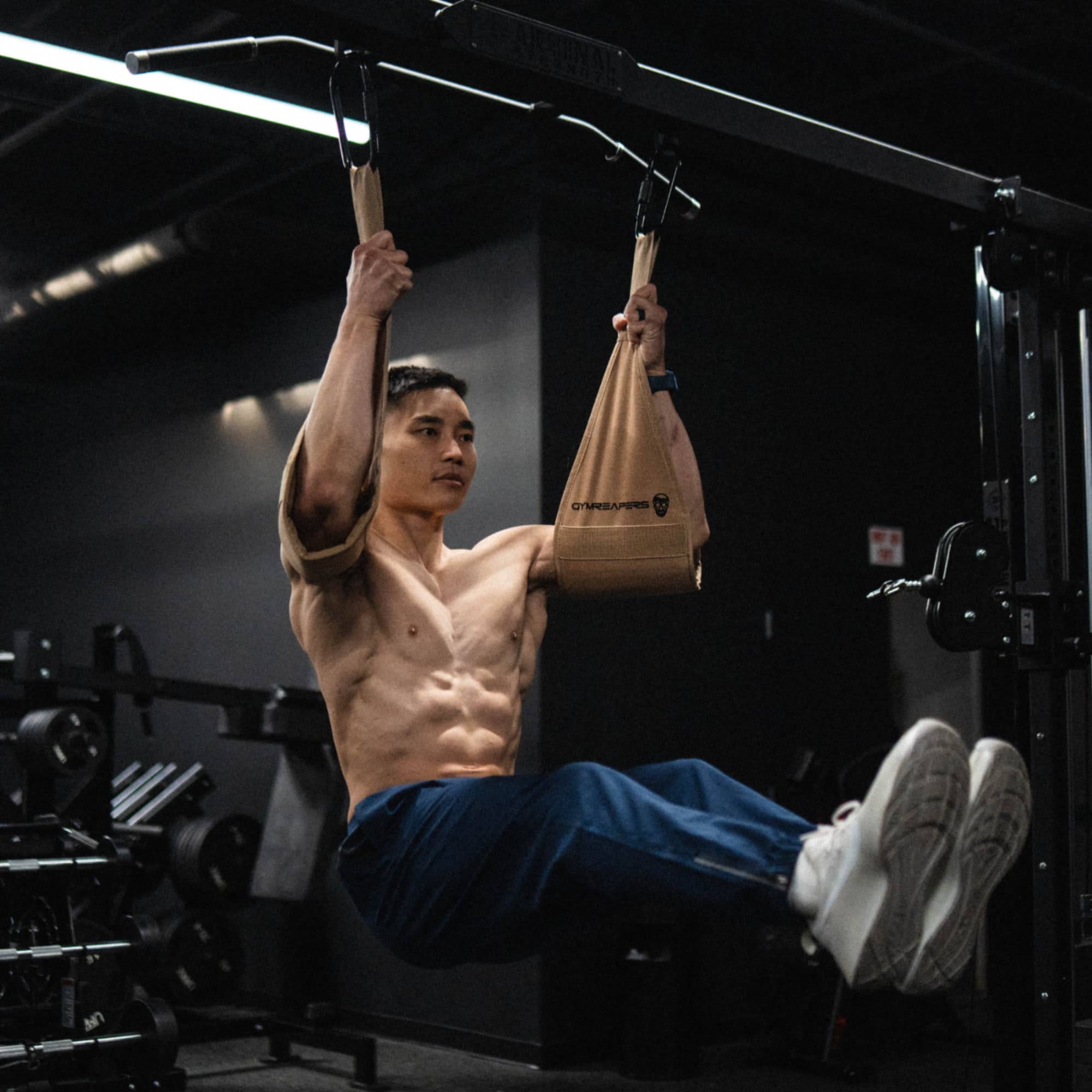 Athlete doing leg raises while using the Gymreapers Ab Straps