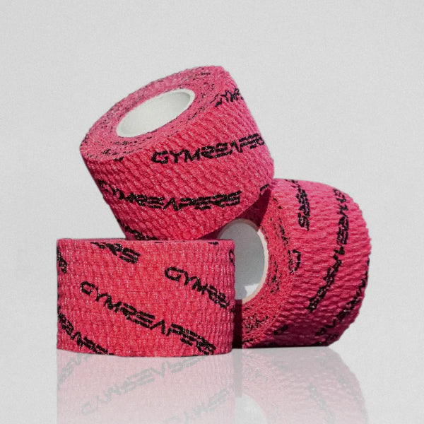 Gymreapers adhesive weightlifting grip tape pink 3 rolls stacked on each other.