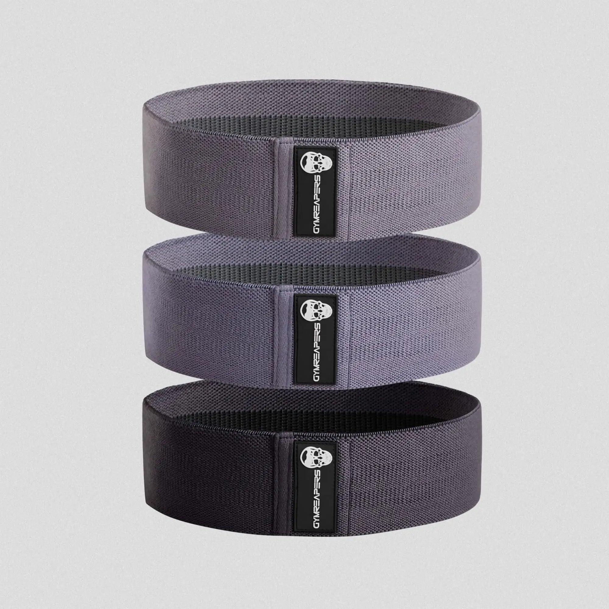 photo of purple hip bands stacked on gray background 