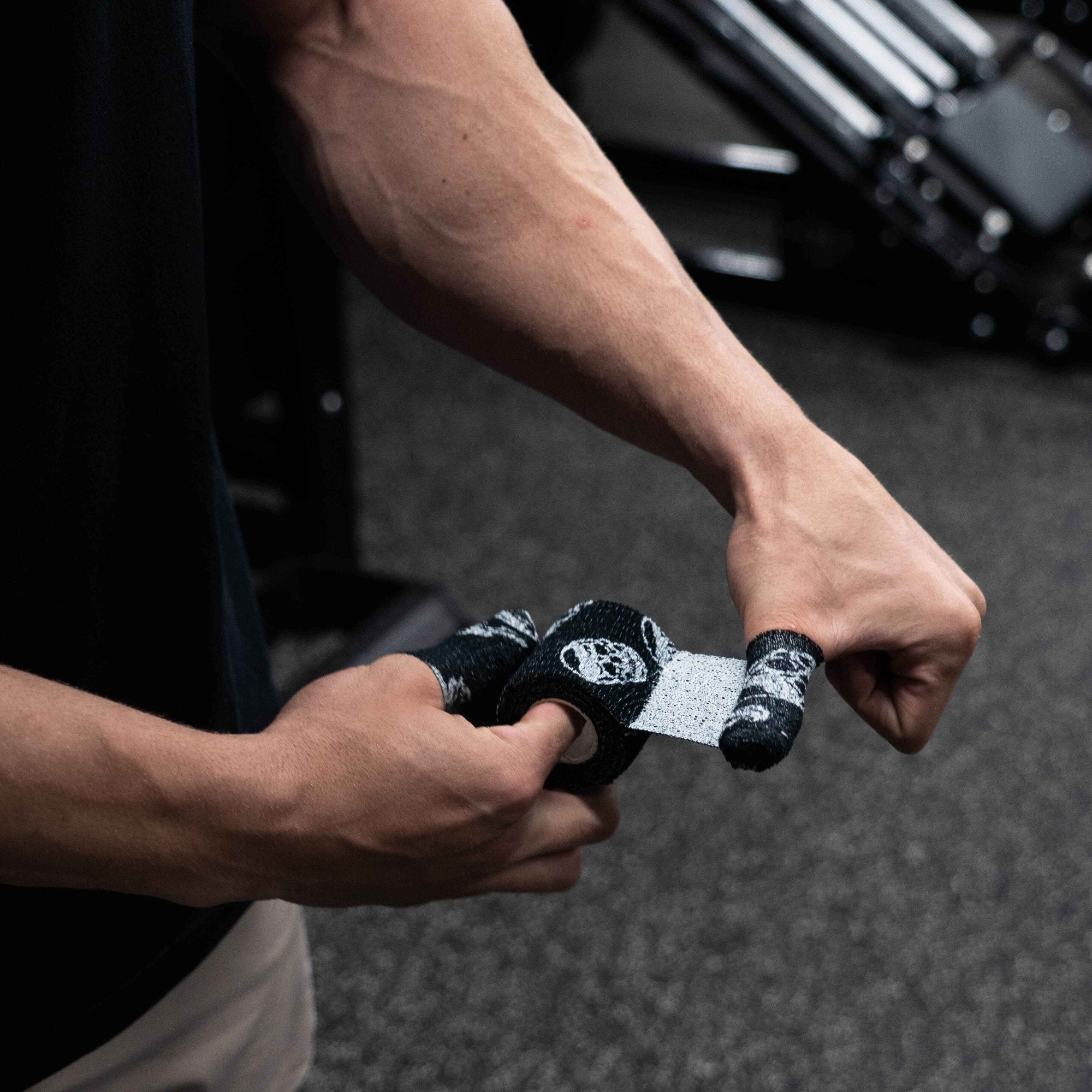 skull tape black being applied to thumb