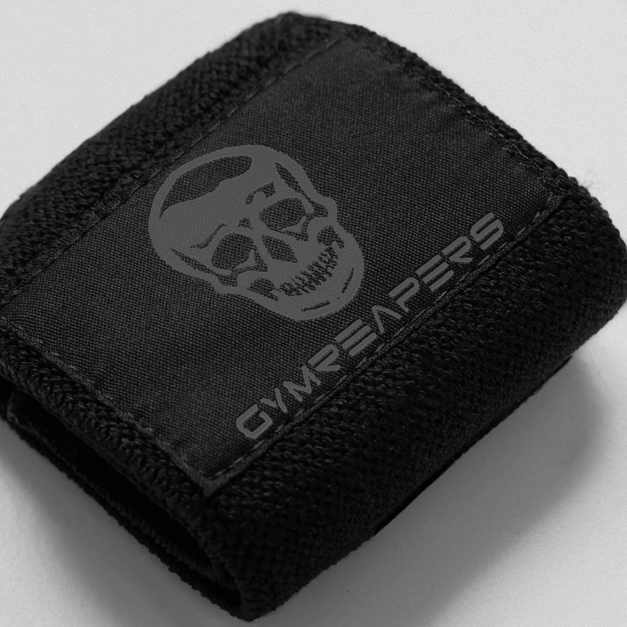 Close up shot of logo on black/black wrist wraps. 